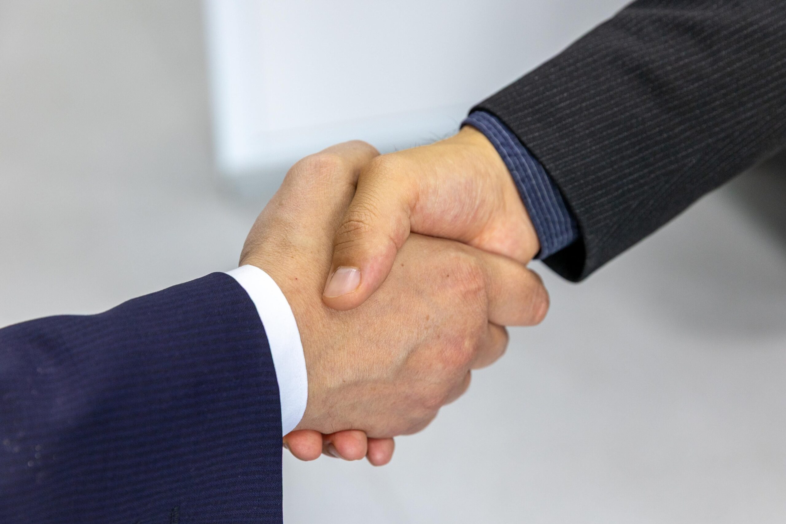 Two people shaking hands in agreement